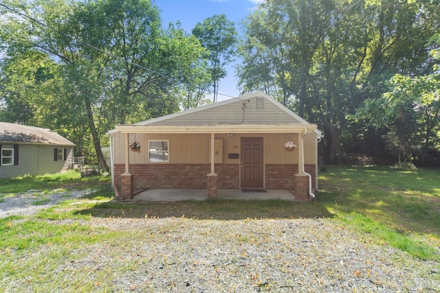 340 N E St, Bethel, OH 45106 - bungalow-style home with brick siding, a front lawn, and covered porch
