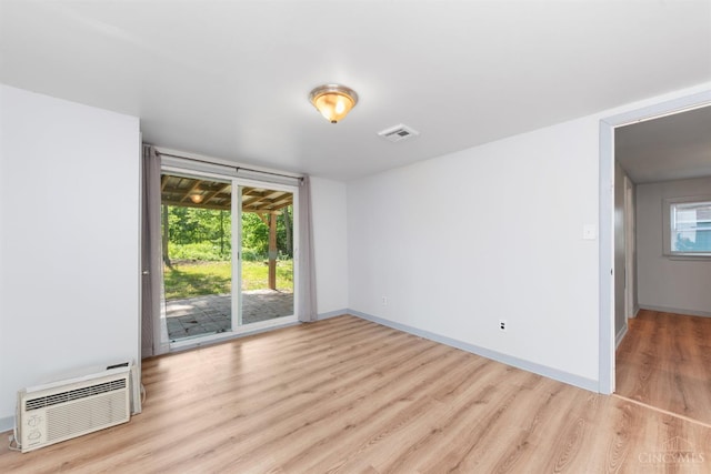 340 N E St, Bethel, OH 45106 - spare room featuring light wood-type flooring and a wall mounted air conditioner
