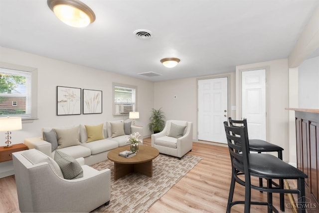 340 N E St, Bethel, OH 45106 - living room featuring plenty of natural light, wood finished floors, and cooling unit