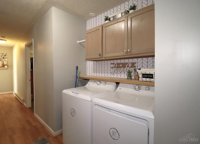 416 N Broadway St, Blanchester, OH 45107 - laundry room featuring washing machine and clothes dryer, cabinet space, wood finished floors, and a textured ceiling