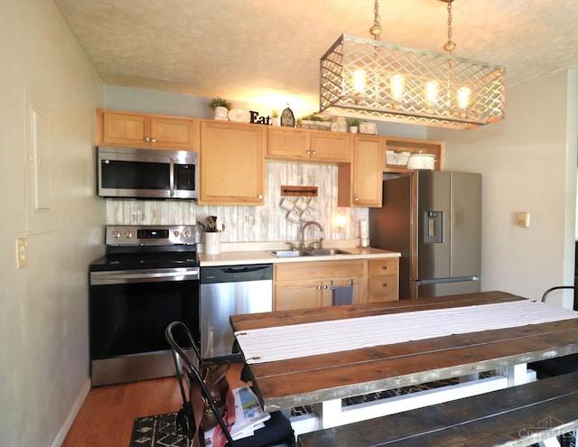416 N Broadway St, Blanchester, OH 45107 - kitchen with appliances with stainless steel finishes, light brown cabinetry, light countertops, and wood finished floors