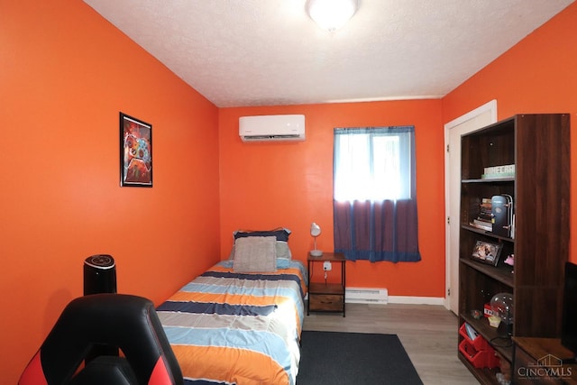 416 N Broadway St, Blanchester, OH 45107 - bedroom with a wall unit AC, wood finished floors, and baseboard heating