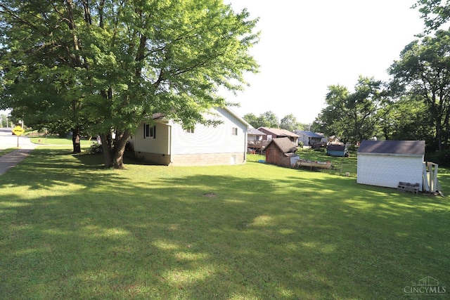 416 N Broadway St, Blanchester, OH 45107 - view of grassy yard featuring a storage unit