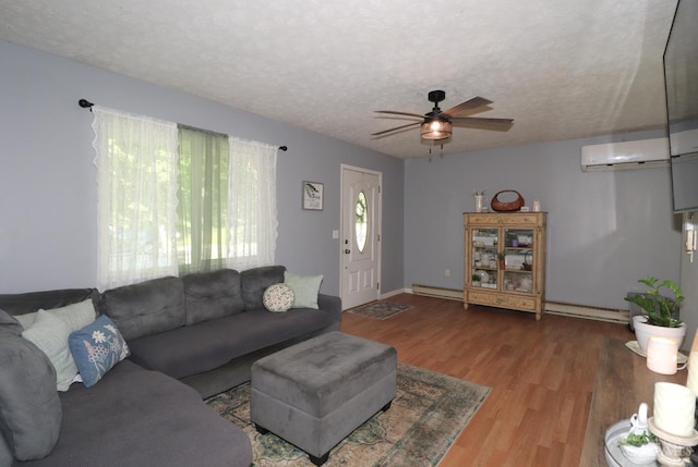 416 N Broadway St, Blanchester, OH 45107 - living room featuring a baseboard heating unit, wood finished floors, ceiling fan, a textured ceiling, and an AC wall unit