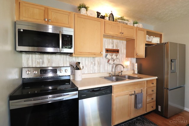 416 N Broadway St, Blanchester, OH 45107 - kitchen featuring stainless steel appliances, light brown cabinetry, light countertops, a textured ceiling, and decorative backsplash