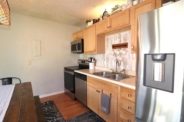 416 N Broadway St, Blanchester, OH 45107 - kitchen with stainless steel appliances, light brown cabinetry, light countertops, wood finished floors, and electric panel