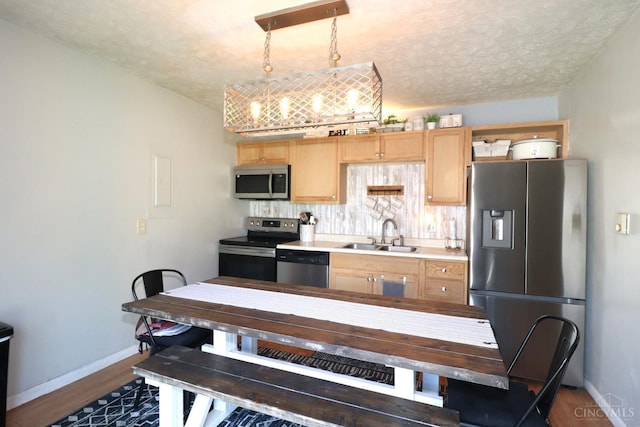 416 N Broadway St, Blanchester, OH 45107 - kitchen featuring stainless steel appliances, light countertops, dark wood-style floors, light brown cabinets, and a textured ceiling