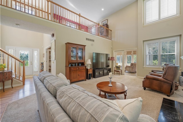 6911 Cozaddale Rd, Goshen, OH 45122 - living room with a towering ceiling, healthy amount of natural light, stairway, recessed lighting, and light carpet