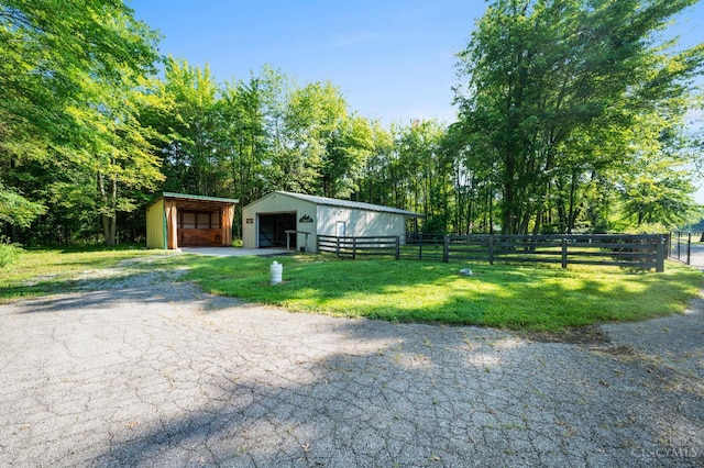 6911 Cozaddale Rd, Goshen, OH 45122 - view of front facade featuring a pole building, an outdoor structure, a detached garage, and driveway
