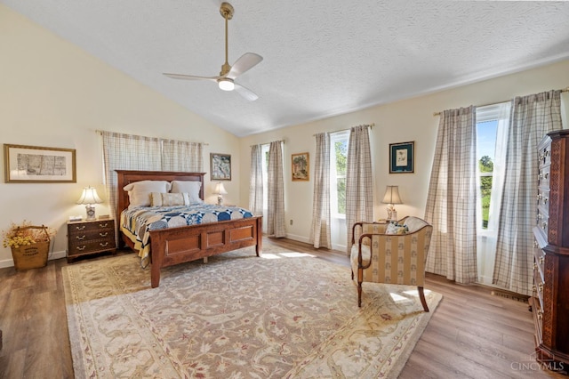 6911 Cozaddale Rd, Goshen, OH 45122 - bedroom with wood finished floors, lofted ceiling, a textured ceiling, and a ceiling fan
