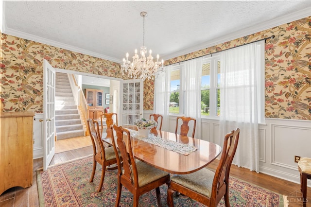 6911 Cozaddale Rd, Goshen, OH 45122 - dining area featuring wallpapered walls, wainscoting, stairway, a chandelier, and a textured ceiling