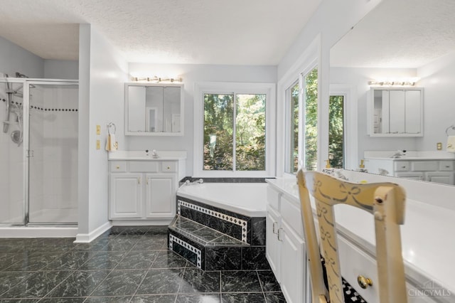6911 Cozaddale Rd, Goshen, OH 45122 - bathroom with a shower stall, two vanities, a garden tub, a textured ceiling, and marble finish floors