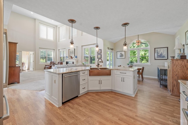 6911 Cozaddale Rd, Goshen, OH 45122 - kitchen featuring stainless steel dishwasher, light wood-type flooring, a fireplace, white cabinets, and decorative light fixtures