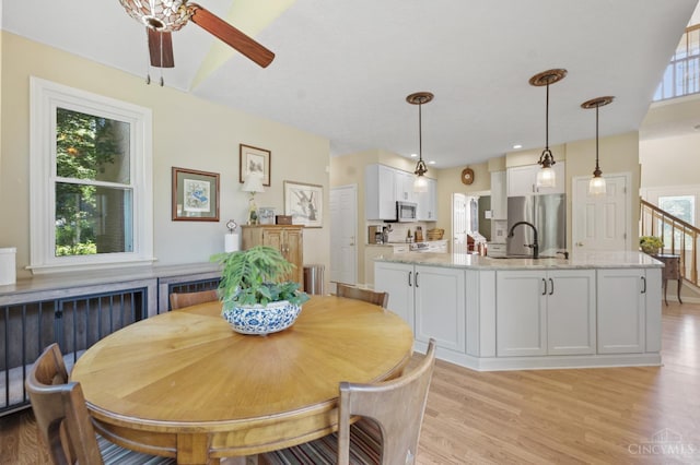 6911 Cozaddale Rd, Goshen, OH 45122 - dining space with light wood finished floors and ceiling fan