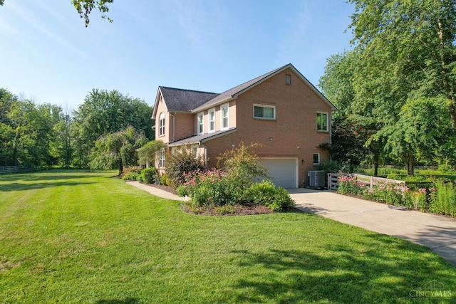 6911 Cozaddale Rd, Goshen, OH 45122 - view of side of property featuring brick siding, driveway, an attached garage, and a yard