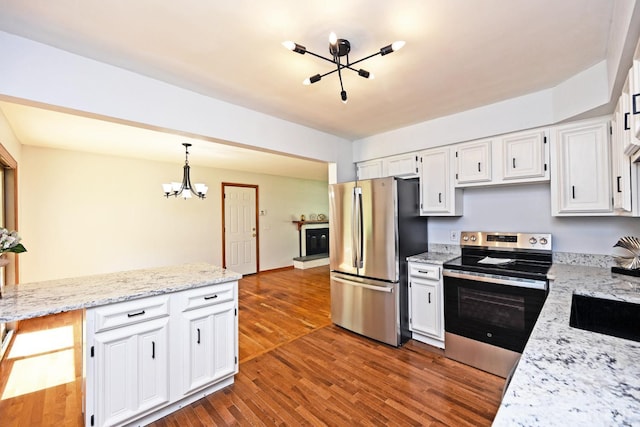 5428 Tallawanda Dr, Fairfield, OH 45014 - kitchen with stainless steel appliances, a chandelier, white cabinets, hanging light fixtures, and dark wood finished floors