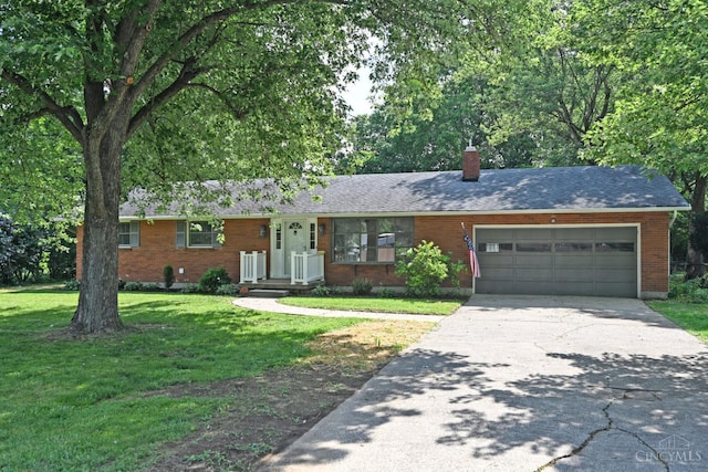 5428 Tallawanda Dr, Fairfield, OH 45014 - ranch-style home featuring a front yard, concrete driveway, a chimney, brick siding, and an attached garage