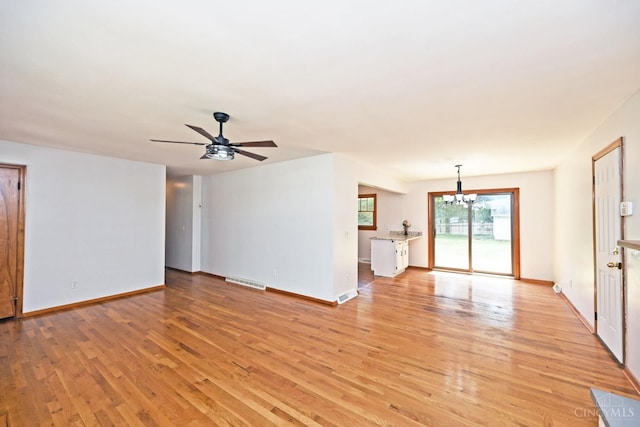 5428 Tallawanda Dr, Fairfield, OH 45014 - unfurnished living room with a chandelier, light wood-style floors, and ceiling fan