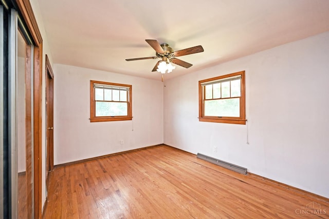 5428 Tallawanda Dr, Fairfield, OH 45014 - unfurnished bedroom with a baseboard heating unit, light wood-type flooring, a closet, and a ceiling fan