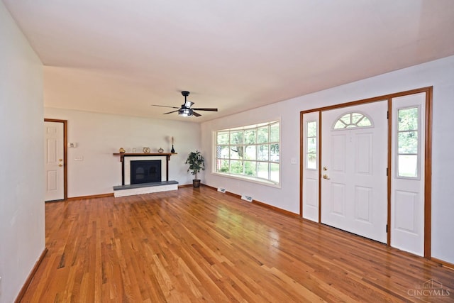 5428 Tallawanda Dr, Fairfield, OH 45014 - entryway featuring light wood-style floors, a ceiling fan, and a glass covered fireplace