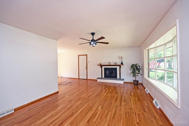 5428 Tallawanda Dr, Fairfield, OH 45014 - unfurnished living room with light wood finished floors, a ceiling fan, and a glass covered fireplace