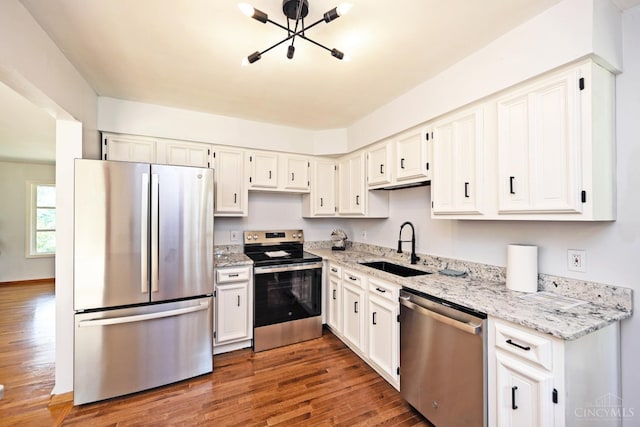 5428 Tallawanda Dr, Fairfield, OH 45014 - kitchen with stainless steel appliances, wood finished floors, light stone countertops, and white cabinets