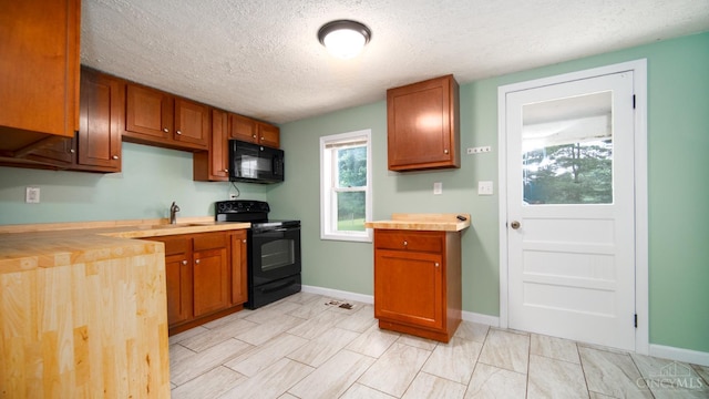 2662 Spring St, Bethel, OH 45106 - kitchen with black appliances, a textured ceiling, wood counters, and brown cabinets