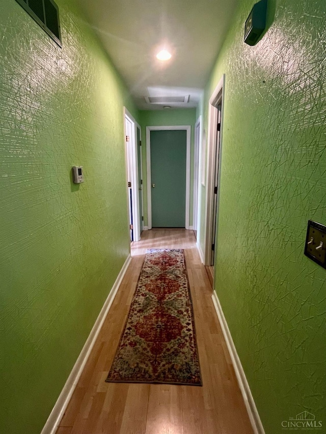 5674 Windsong Ln, Milford, OH 45150 - hall with wood finished floors, attic access, and a textured wall