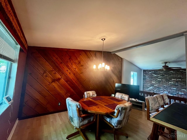 5674 Windsong Ln, Milford, OH 45150 - dining area with wood finished floors, wooden walls, a chandelier, ceiling fan, and vaulted ceiling