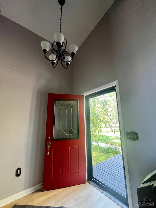5674 Windsong Ln, Milford, OH 45150 - foyer entrance with a chandelier, light wood-style flooring, high vaulted ceiling, and healthy amount of natural light