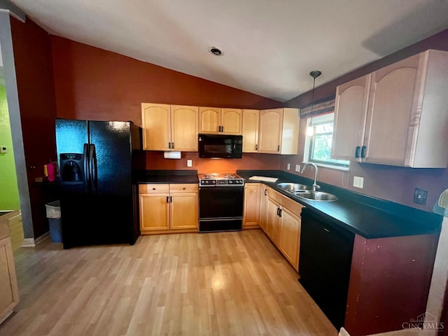 5674 Windsong Ln, Milford, OH 45150 - kitchen with black appliances, lofted ceiling, light wood-type flooring, dark countertops, and hanging light fixtures