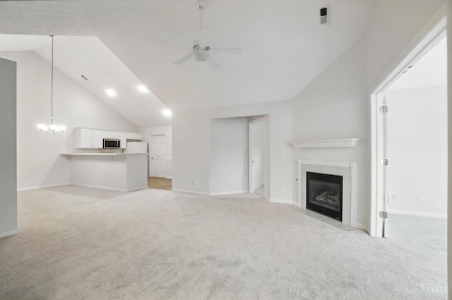 1300 Muirfield, Miami Twp, OH 45150 - unfurnished living room with light carpet, a ceiling fan, a fireplace with flush hearth, a chandelier, and recessed lighting