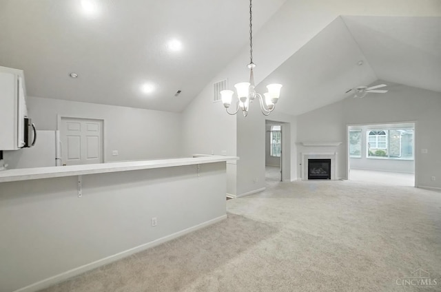 1300 Muirfield, Miami Twp, OH 45150 - unfurnished living room with vaulted ceiling, ceiling fan, light carpet, a chandelier, and a fireplace