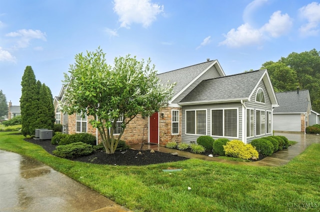 1300 Muirfield, Miami Twp, OH 45150 - obstructed view of property featuring a shingled roof, a front yard, and stone siding