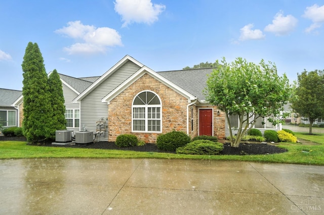 1300 Muirfield, Miami Twp, OH 45150 - view of front facade with stone siding and roof with shingles