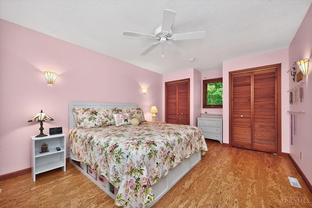 10869 Sand Run Rd, Whitewater Twp, OH 45030 - bedroom with two closets, wood finished floors, and ceiling fan