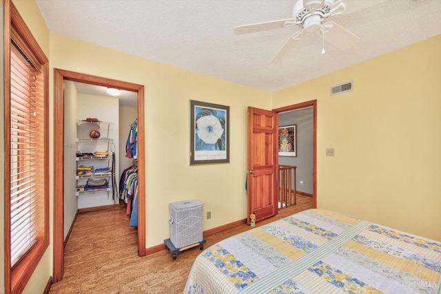 10869 Sand Run Rd, Whitewater Twp, OH 45030 - bedroom with light carpet, a textured ceiling, a spacious closet, and a ceiling fan