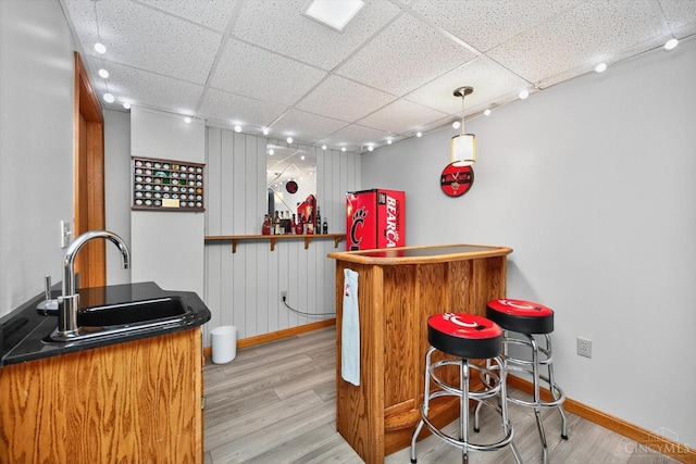 10869 Sand Run Rd, Whitewater Twp, OH 45030 - indoor bar featuring a drop ceiling, light wood-type flooring, and decorative light fixtures