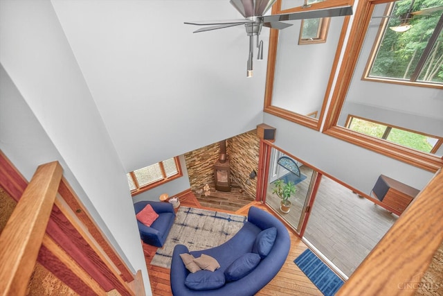 10869 Sand Run Rd, Whitewater Twp, OH 45030 - staircase with wood finished floors, a ceiling fan, and a wood stove