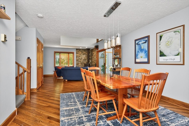 10869 Sand Run Rd, Whitewater Twp, OH 45030 - dining area with wood finished floors, a textured ceiling, and stairway