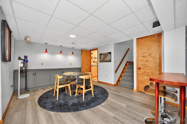 10869 Sand Run Rd, Whitewater Twp, OH 45030 - dining room featuring light wood-type flooring, a drop ceiling, and stairway