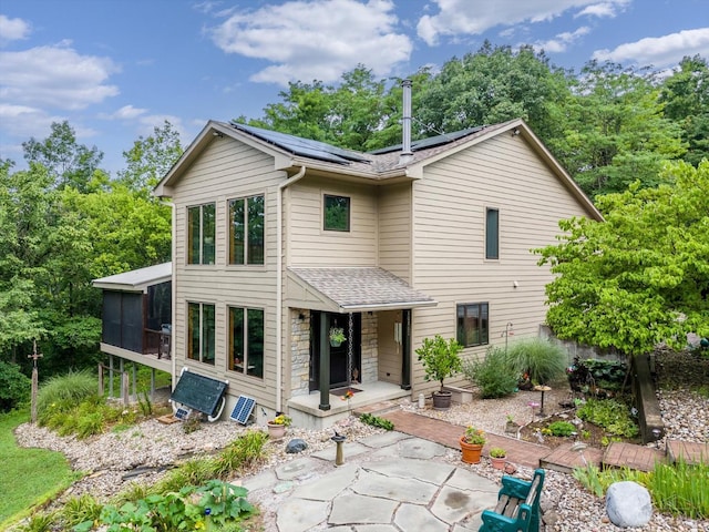 10869 Sand Run Rd, Whitewater Twp, OH 45030 - back of house with a sunroom, roof with shingles, solar panels, and a patio