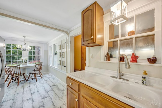 799 Millville Oxford Rd, Hamilton, OH 45013 - kitchen with ornamental molding, brown cabinets, light countertops, decorative light fixtures, and a chandelier