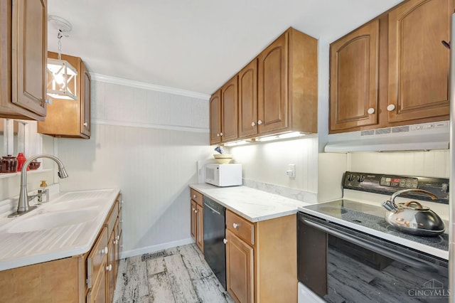 799 Millville Oxford Rd, Hamilton, OH 45013 - kitchen with electric range oven, brown cabinets, under cabinet range hood, light countertops, and crown molding