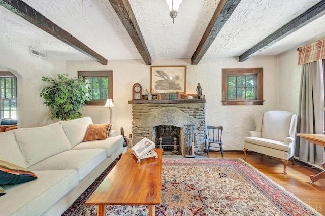 799 Millville Oxford Rd, Hamilton, OH 45013 - living room featuring a textured wall, wood finished floors, a textured ceiling, beam ceiling, and a fireplace