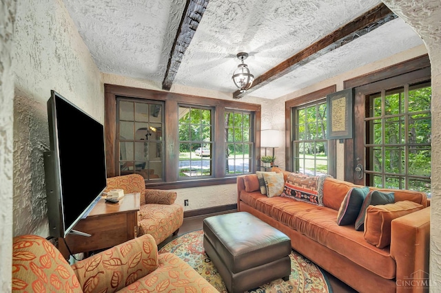 799 Millville Oxford Rd, Hamilton, OH 45013 - living area with healthy amount of natural light, beamed ceiling, a textured wall, and a textured ceiling