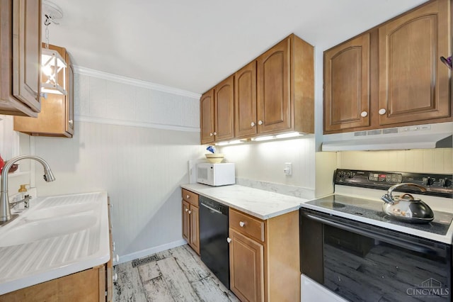799 Millville Oxford Rd, Hamilton, OH 45013 - kitchen with white appliances, brown cabinets, under cabinet range hood, light wood-type flooring, and light countertops