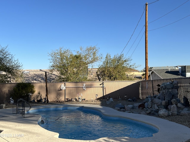 view of swimming pool featuring a fenced in pool and fence