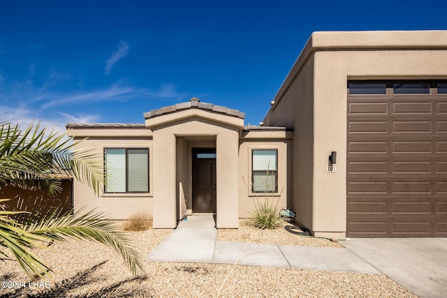 view of exterior entry with a garage