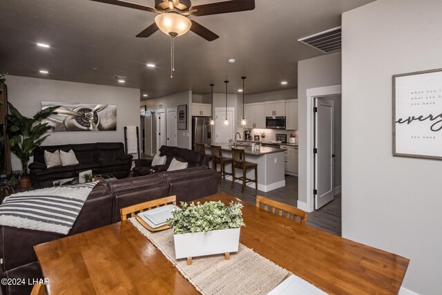 living room featuring sink, dark hardwood / wood-style floors, and ceiling fan